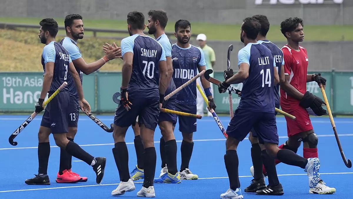 Indias Harmanpreet Singh, second left, celebrates with teammates