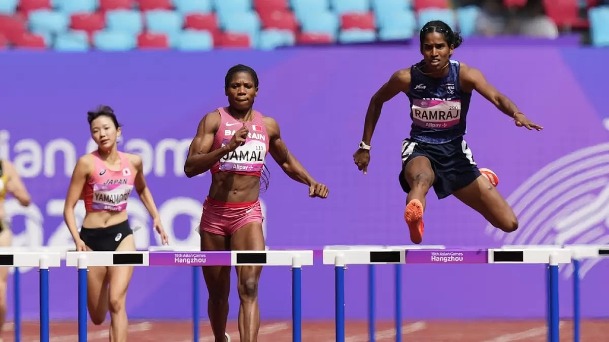 Vithya Ramraj (R) in action during her 400m hurdles heat in Hangzhou.