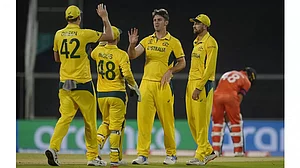 Mitchell Marsh, center, celebrates the wicket of Netherlands Vikram Singh in a warm-up match