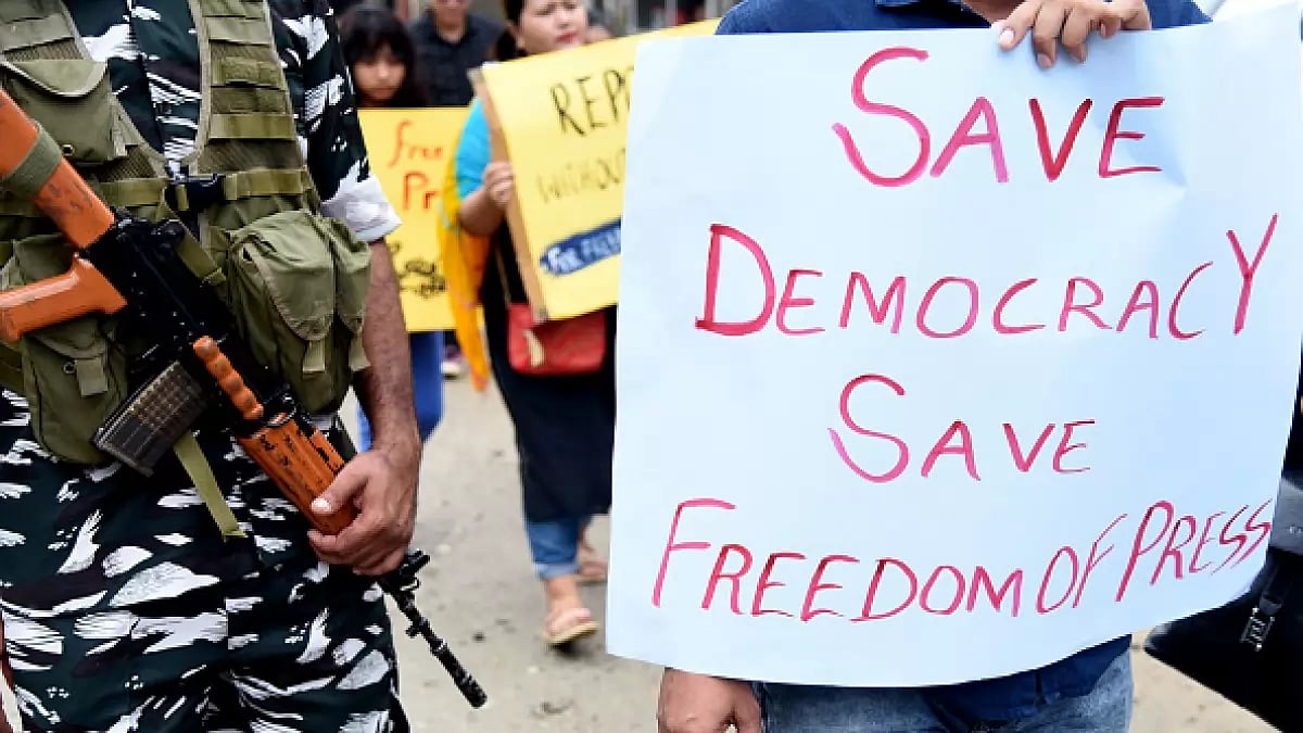 A poster that says, save democracy save freedom press is seen during the protest.
