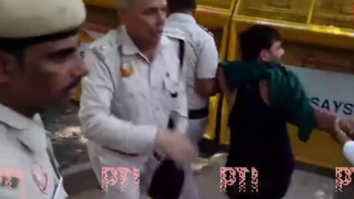 Delhi Police detains an AAP worker during protest outside headquarters today