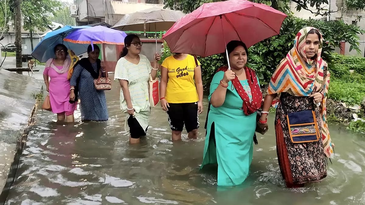 Women wades through a waterlogged street