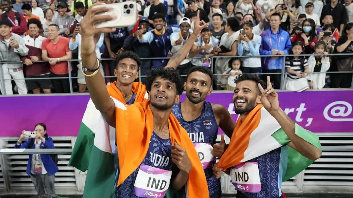 India's gold-winning 4x400m relay quartet celebrates with fans in Hangzhou.