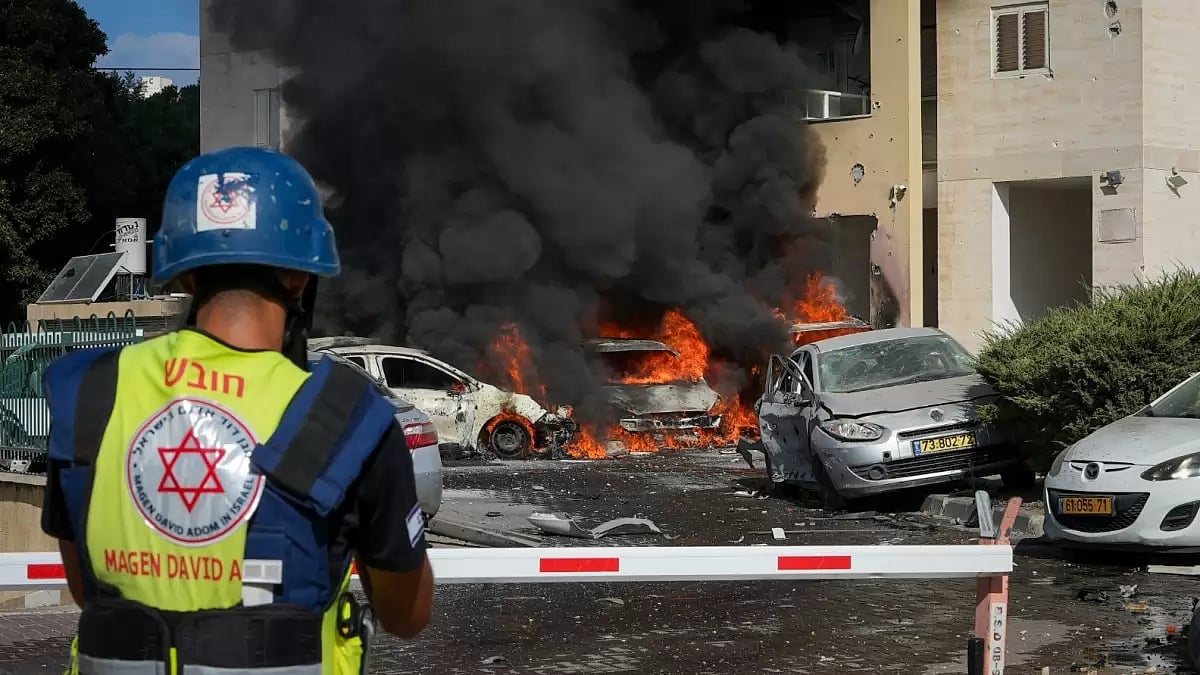Cars burn after a rocket fired from the Gaza Strip hit a parking lot and a residential building in Ashkelon, southern Israel. (AP Photo/Tsafrir Abayov)