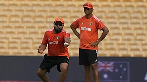 Rohit Sharma (L) trains as Rahul Dravid looks on ahead of the India vs Australia match.