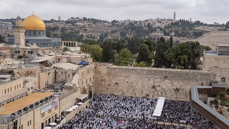 Jews take part in priestly blessing during the weeklong holiday of Sukkot in front of the Western Wall, the holiest site of Jews in Jerusalem. (AP Photo/Ohad Zwigenberg) - null
