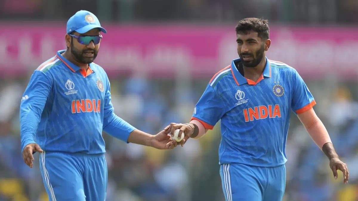India's captain Rohit Sharma, left, hands over the ball to India's Jasprit Bumrah