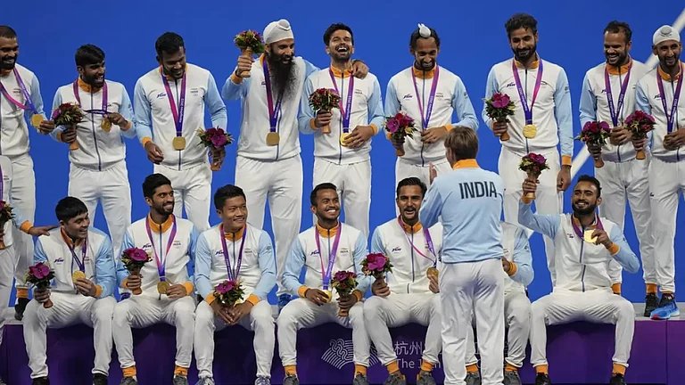 The victorious Indian men's hockey team celebrates on the podium in Hangzhou. - null