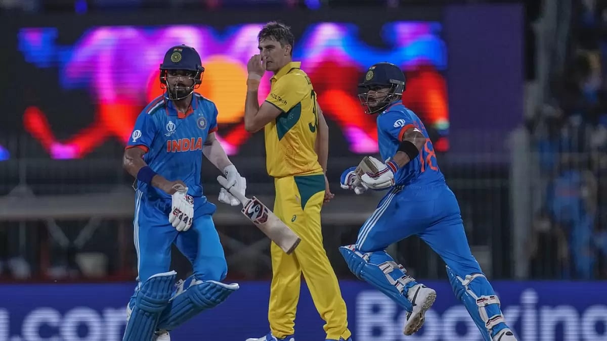 Virat Kohli and KL Rahul (L) during their partnership as Pat Cummins looks on in Chennai.