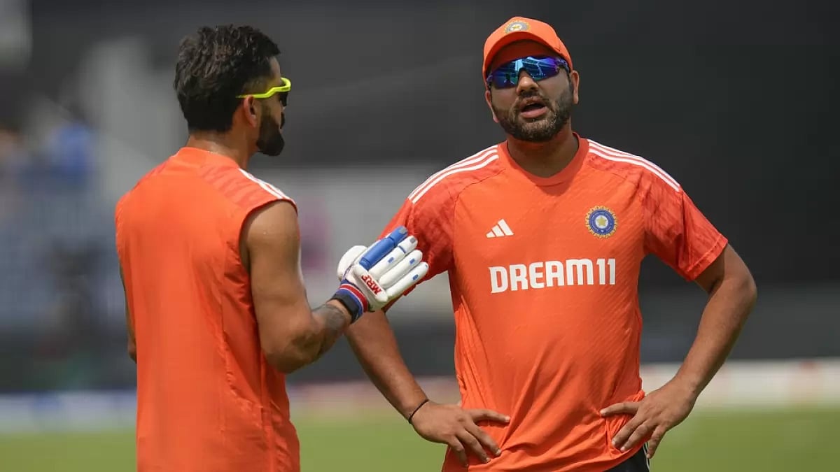 Rohit Sharma (R) and Virat Kohli in Team India's orange training jerseys.