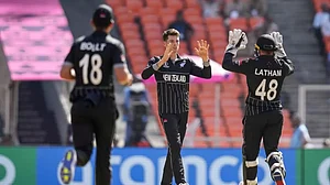 Mitchell Santner (centre) celebrates a wicket with teammates during the 2023 ODI World Cup.