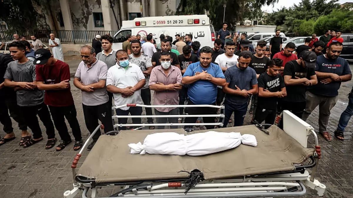 People gather at Shifa Hospital to pay tribute to a boy killed in Israeli strikes in Gaza