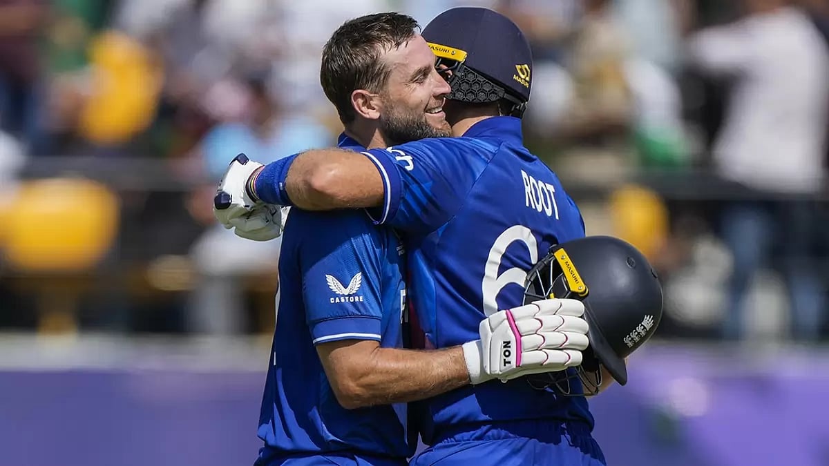 England's Dawid Malan, left, celebrates his century with Joe Root