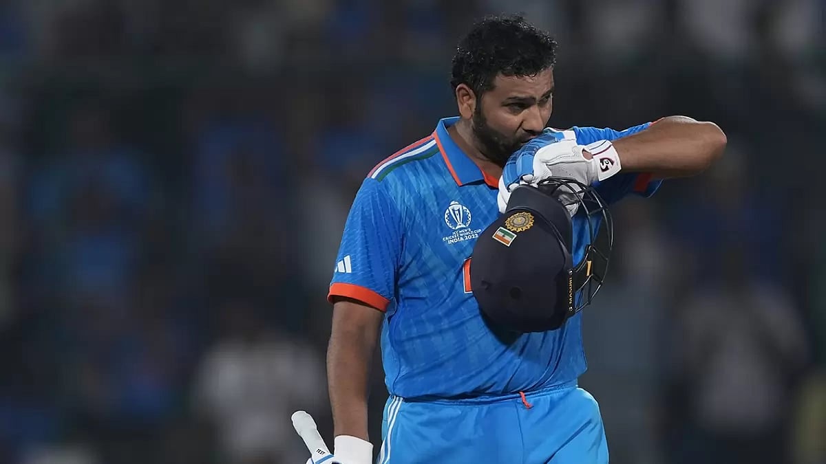 India captain Rohit Sharma kisses his glove as he celebrates his century