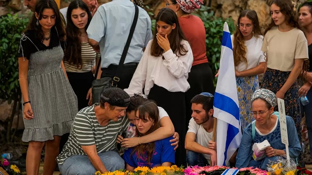 Mourners attend the funeral of Israeli soldier Shilo Rauchberger at the Mount Herzl cemetery in Jerusalem, Israel.