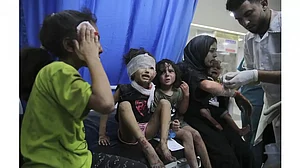 Palestinian children wounded in Israeli strikes are brought to Shifa Hospital in Gaza City.