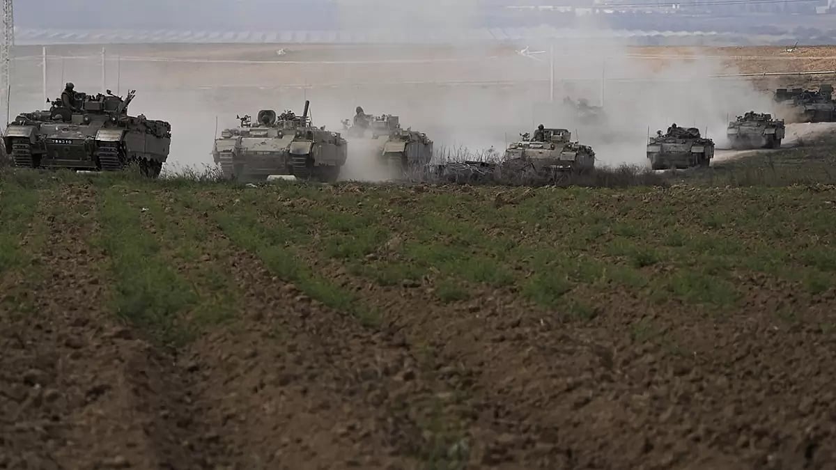 Israeli armoured personnel carriers (APC) head towards the Gaza Strip