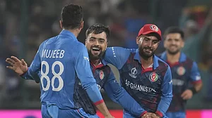 Rashid Khan (2nd from left) celebrates Adil Rashid's wicket in Delhi on Sunday.