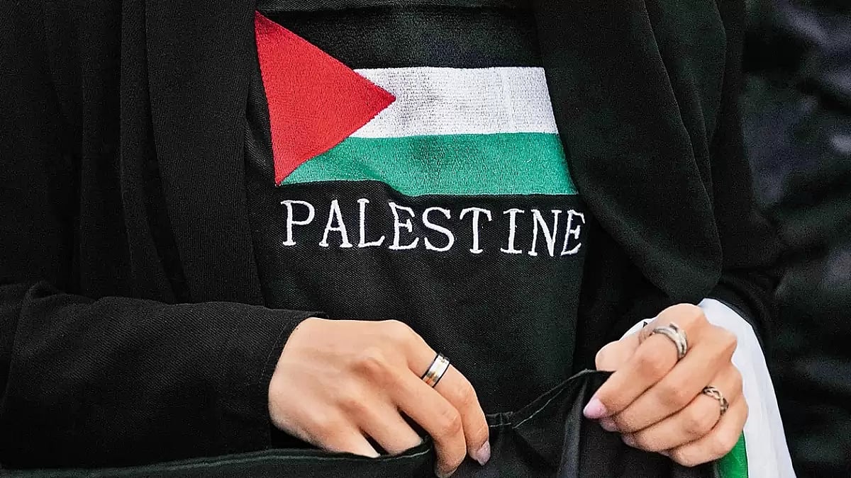 Hand in Hand: A woman protests against Israeli air strikes on Gaza in Madrid, Spain