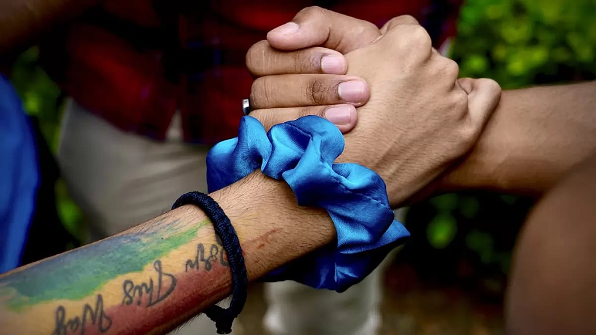 LGBTQ community supporters and members held hands as they waited for the Supreme Court verdict