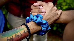 LGBTQ community supporters and members held hands as they waited for the Supreme Court verdict