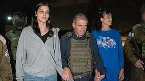 File Photo : Judith Raanan (right) and her 17-year-old daughter Natalie being escorted by Gal Hirsch, the Israeli official appointed for hostage-related affairs after Hamas released them from captivity in Gaza Strip.