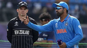 India captain Rohit Sharma (right) flips the coin at the toss as NZ skipper Tom Latham watches on