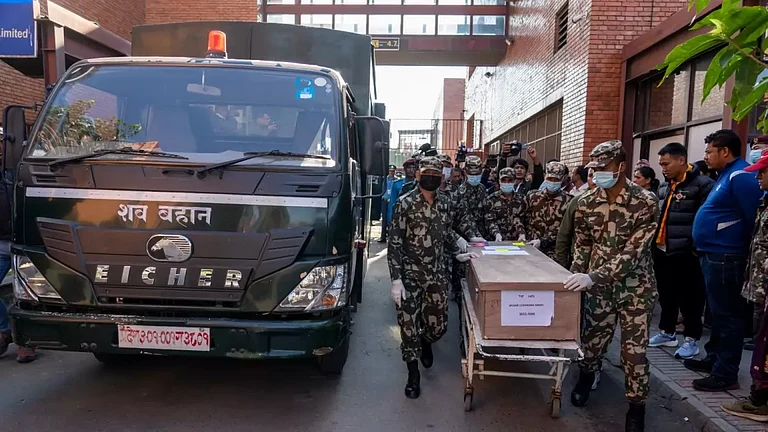One of the coffins containing bodies of Nepali nationals who were killed by the Hamas attack in Israel arrives at Tribhuvan International Airport in Kathmandu, Nepal, Sunday, Oct. 22, 2023. Nepal has repatriated bodies of some of 10 Nepali students who were killed during the Hamas attack in Israel two weeks ago. - null