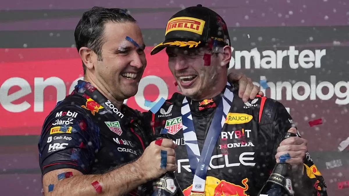Red Bull driver Max Verstappen, of the Netherlands, right, celebrates on the podium