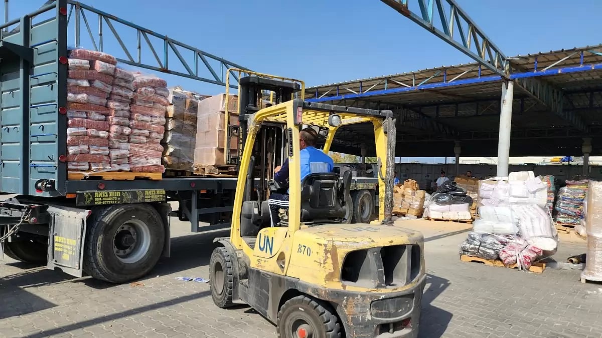 United Nations and Red Crescent workers prepare the aid for distribution to Palestinians in Deir Al-Balah, Gaza Strip.
