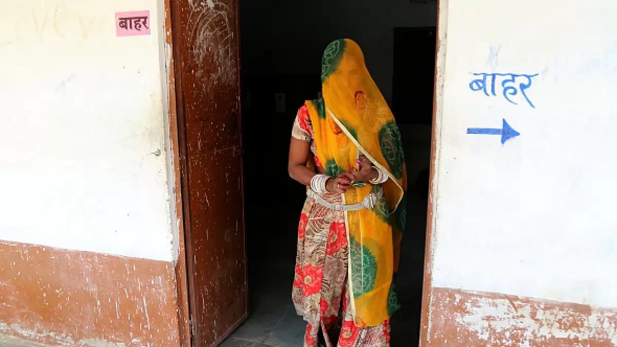 Woman leaves a polling booth after casting vote in outskirts village of Ajmer, Rajasthan.