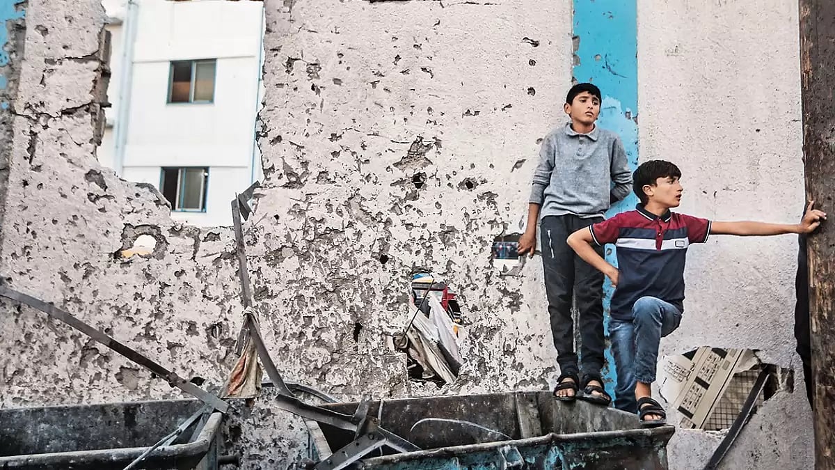 Amid the Ruins: Palestinians inspect the rubble after an Israeli air strike near a school in the Gaza Strip
