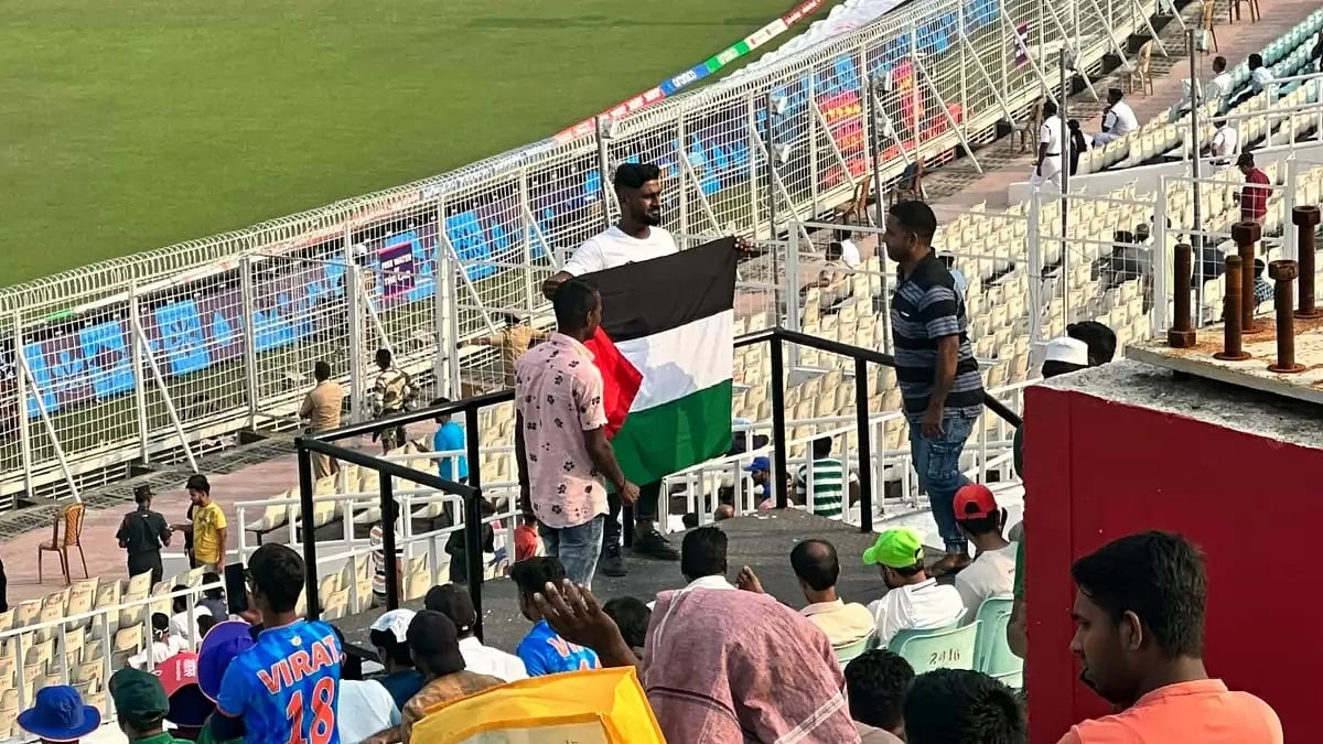 A fan inside the cricket stadium posing with the Palestine flag