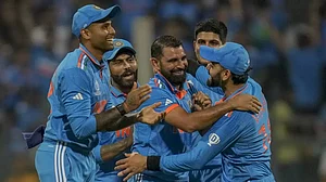 Indian team celebrate a wicket with Mohammed Shami (c) in Mumbai