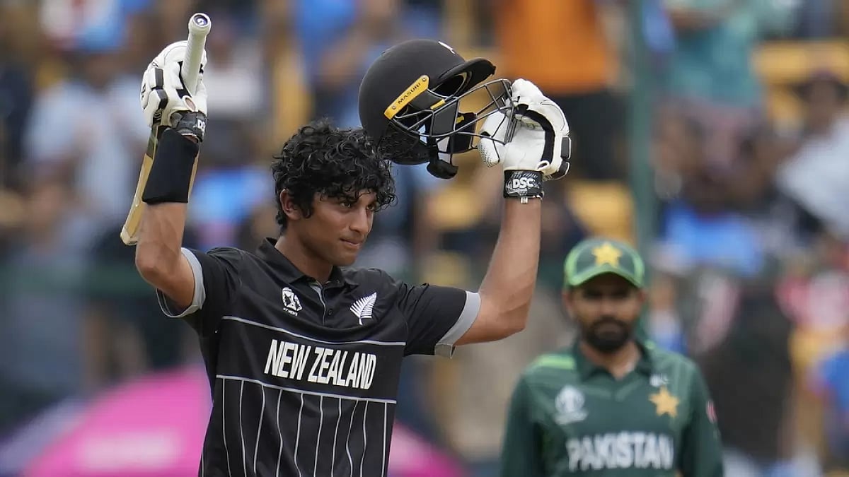 Rachin Ravindra raises his bat after scoring his third ton in the 2023 ODI World Cup.