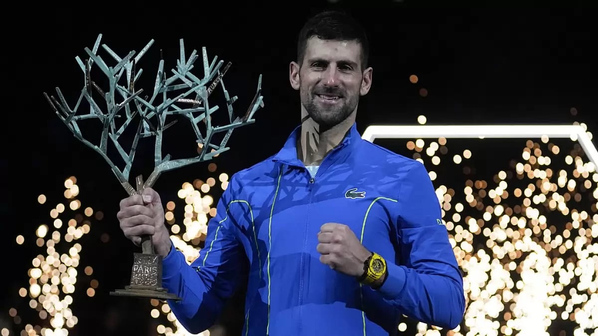 Novak Djokovic holds the Paris Masters Trophy after beating Grigor Dimitrov in the final.