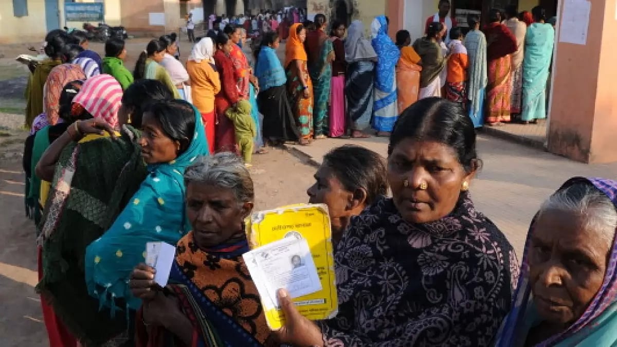 Voters show their Id cards standing in queue to cast their vote at polling booth. Chhattisgarh, 2013