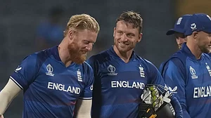 Ben Stokes (left) with Jos Buttler (c) after England's win over Netherlands in Pune
