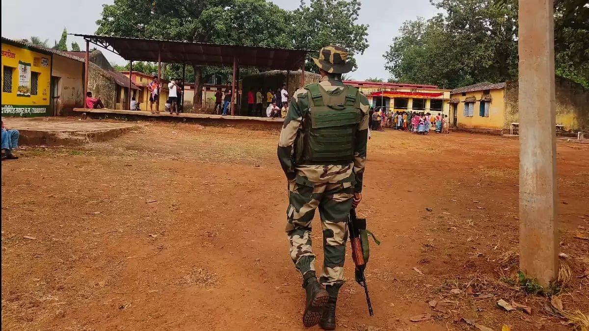 Polling takes place at a polling booth in South Bastar under strict watch of CRPF personnel