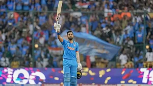 KL Rahul raises his bat after bringing up his ton in the ODI World Cup