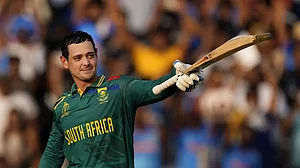 South Africa's wicketkeeper Quinton De Kock celebrates his century during the ICC Men's Cricket World Cup match between New Zealand and South Africa, in Pune