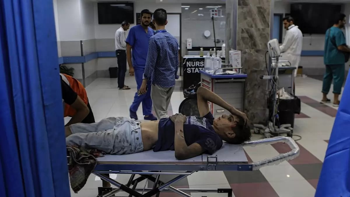 A wounded Palestinian boy arrives to the emergency room of the al-Shifa hospital