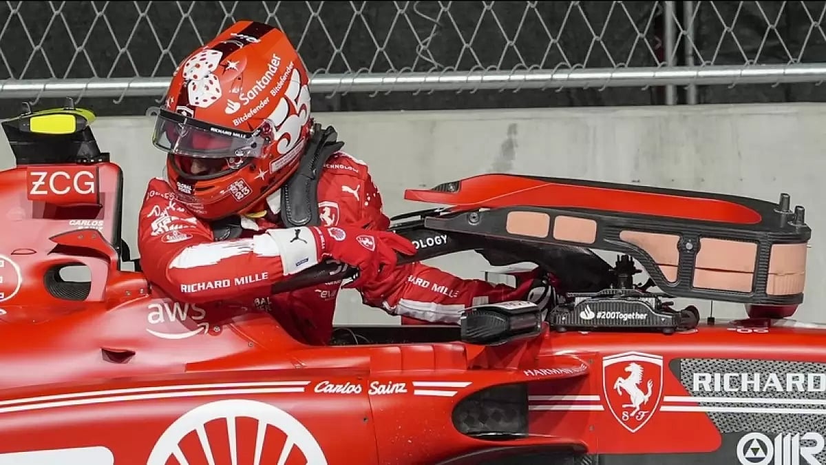 Carlos Sainz climbs out of his car damaged by a water valve cover during the first practice session of Las Vegas Grand Prix.