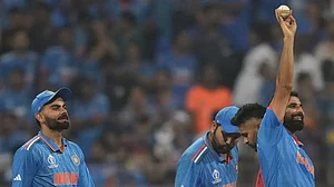 Virat Kohli (L), Rohit Sharma (Center), and Mohammed Shami (R) after a five-wicket haul during the f