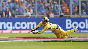 Travis Head completes the catch to dismiss Rohit Sharma in the India vs Australia final.
