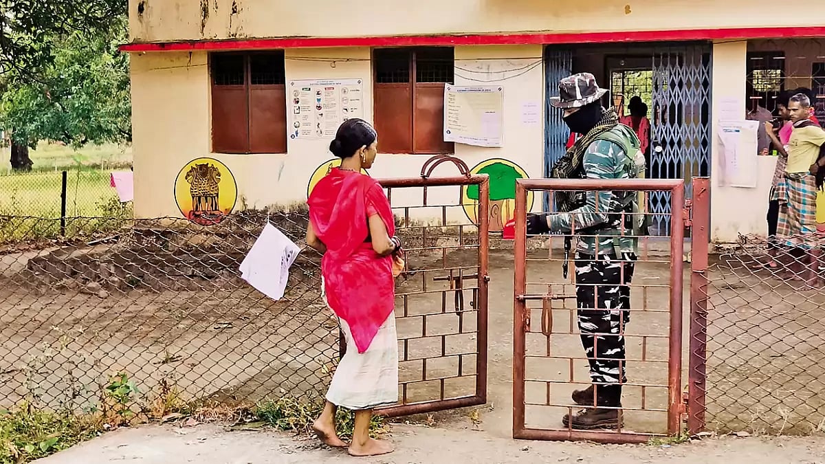 Little Faith: An Adivasi woman enters a deserted polling booth under heavy security cover in south Bastar