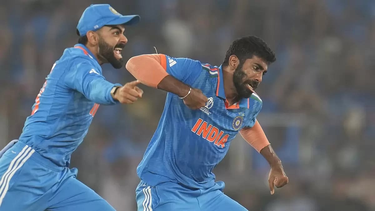 India's Jasprit Bumrah and Virat Kohli celebrate the wicket of Australia's Steve Smith during the ICC Cricket World Cup final match between India and Australia in Ahmedabad.