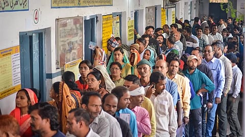 Voters wait in a queue at a polling station to cast their votes in Jabalpur, Madhya Pradesh.