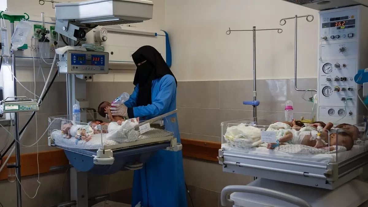 A nurse prepares babies for transport to Egypt after they were evacuated from Shifa Hospital