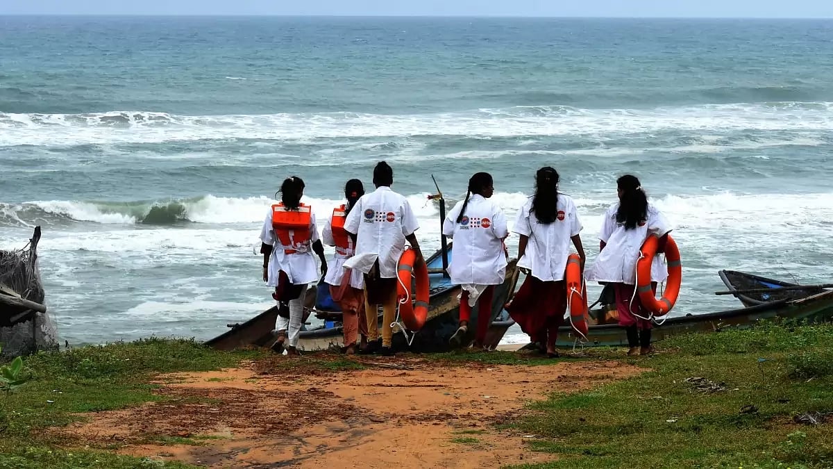 Girl trainees taking stock of the situation on the sea shore. 